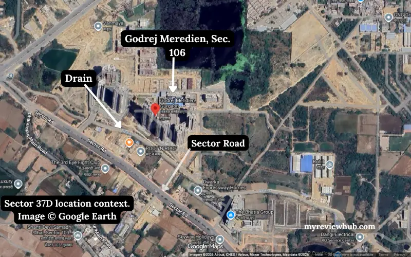 Google Earth satellite view of Godrej Meridien Sector 106 showing surrounding roads, drainage corridor and nearby development parcels.